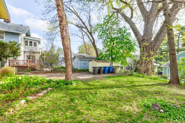 view of yard with a storage shed and an outbuilding