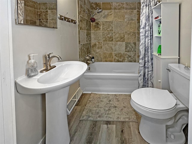 608 12th St, West Des Moines, IA 50265 - full bath featuring toilet, shower / bath combination with curtain, and wood finished floors