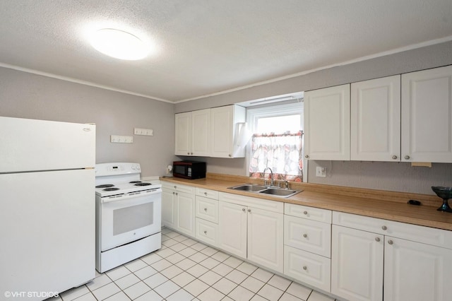 kitchen with white appliances, light countertops, a textured ceiling, white cabinets, and a sink