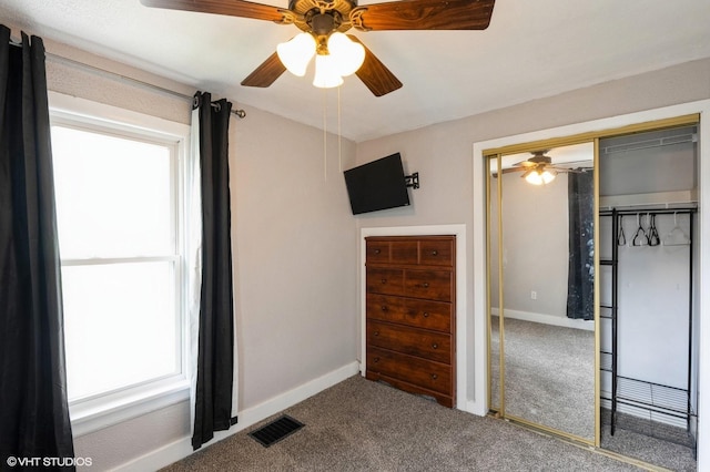 carpeted bedroom featuring visible vents, baseboards, ceiling fan, and a closet
