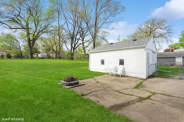 view of yard with fence, a patio area, and an outdoor fire pit