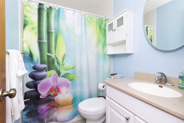 bathroom with vanity, a shower with shower curtain, and toilet