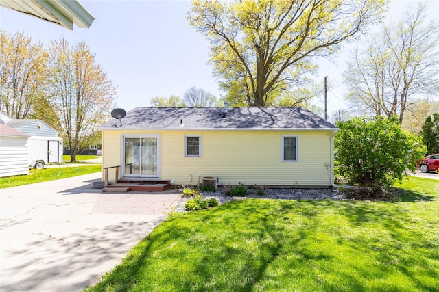 back of property with a yard, cooling unit, and entry steps