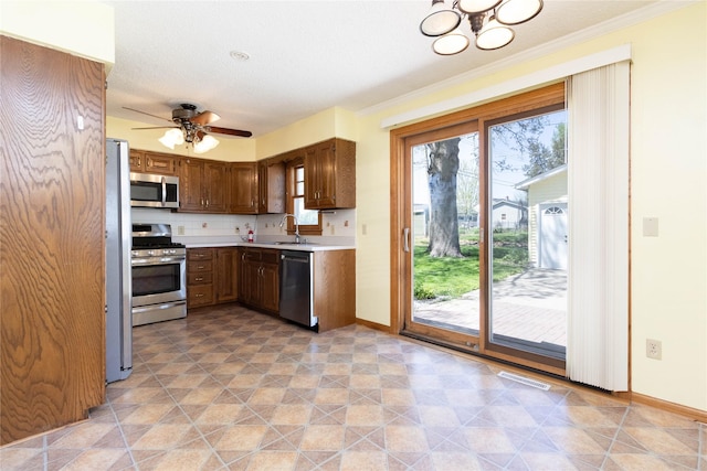 kitchen featuring visible vents, a sink, light countertops, baseboards, and stainless steel appliances