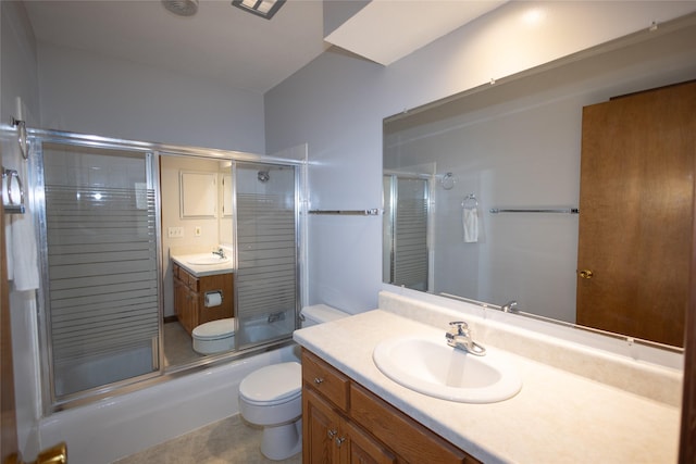 full bathroom with vanity, toilet, and shower / bath combination with glass door