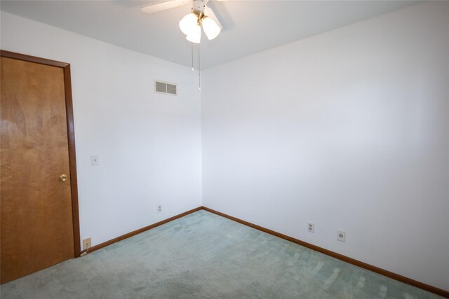 1606 N 8th Ave E, Newton, IA 50208 - carpeted spare room with baseboards, ceiling fan, and visible vents