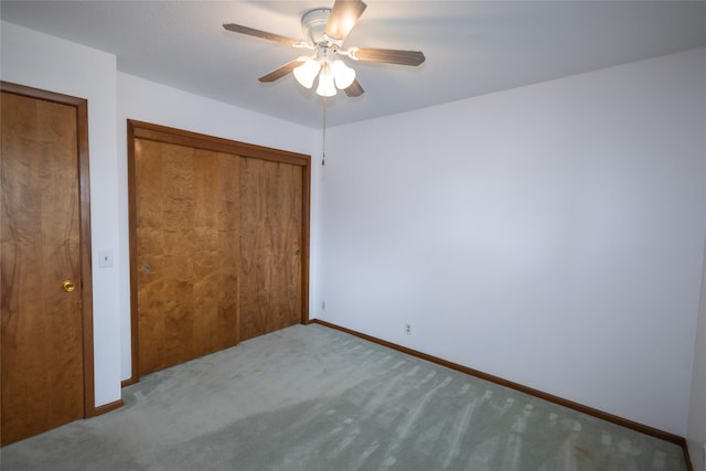 unfurnished bedroom featuring carpet floors, baseboards, a closet, and ceiling fan