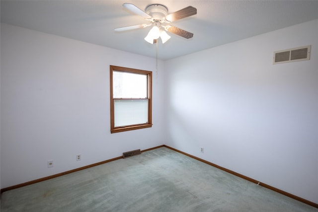 empty room with visible vents, baseboards, ceiling fan, and carpet floors