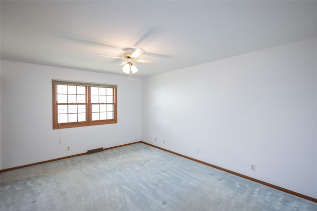 unfurnished room with carpet floors, ceiling fan, baseboards, and visible vents