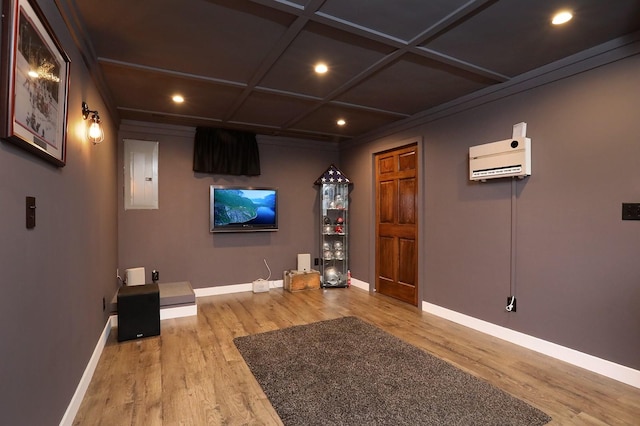cinema featuring recessed lighting, baseboards, wood finished floors, and electric panel