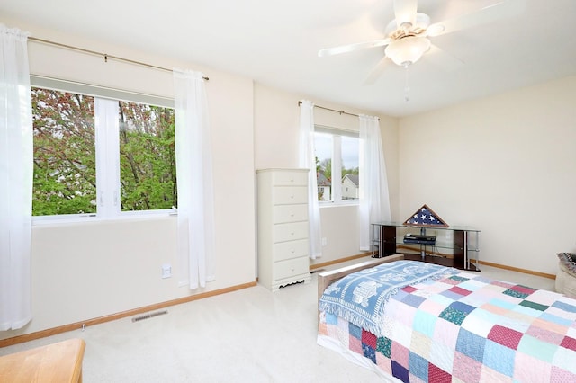 bedroom with carpet floors, baseboards, visible vents, and ceiling fan
