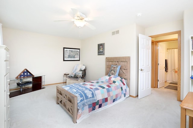 carpeted bedroom with visible vents, baseboards, and ceiling fan