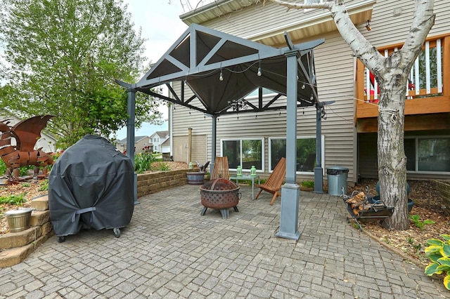 view of patio / terrace featuring a gazebo, an outdoor fire pit, and grilling area