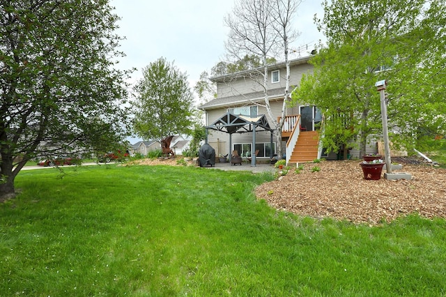 view of yard featuring a wooden deck, stairs, a gazebo, and a patio area