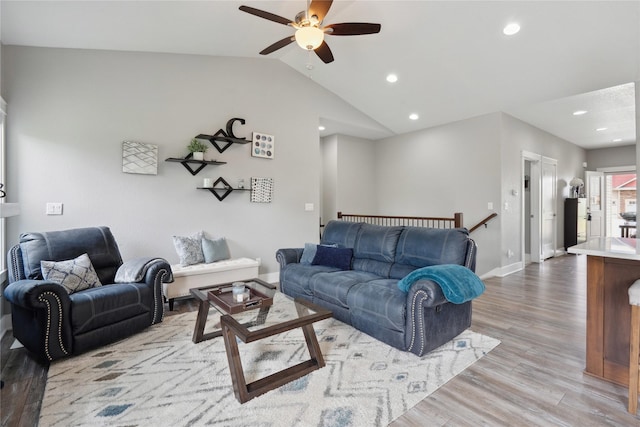 living room featuring light wood-type flooring, a ceiling fan, lofted ceiling, and recessed lighting