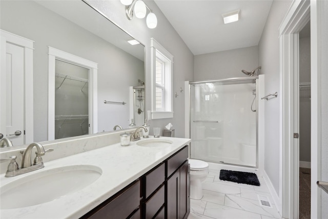full bath featuring a sink, marble finish floor, a stall shower, and toilet