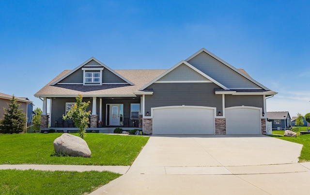 218 34th St SE, Altoona, IA 50009 - craftsman inspired home featuring a front yard, concrete driveway, covered porch, an attached garage, and stone siding