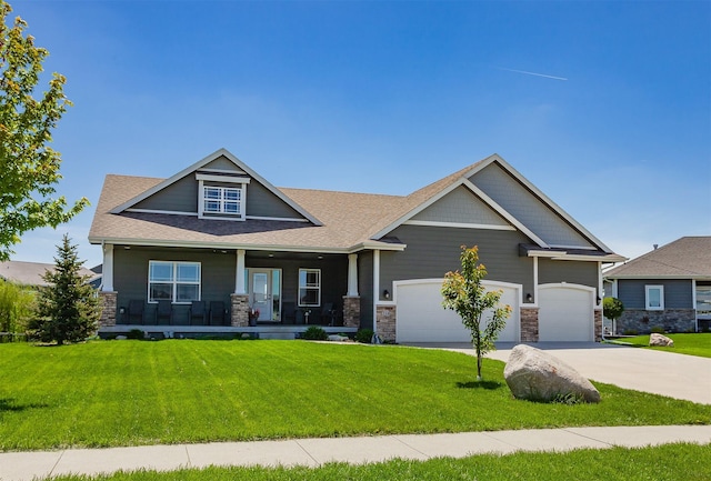 218 34th St SE, Altoona, IA 50009 - craftsman-style house featuring stone siding, covered porch, concrete driveway, and a front lawn