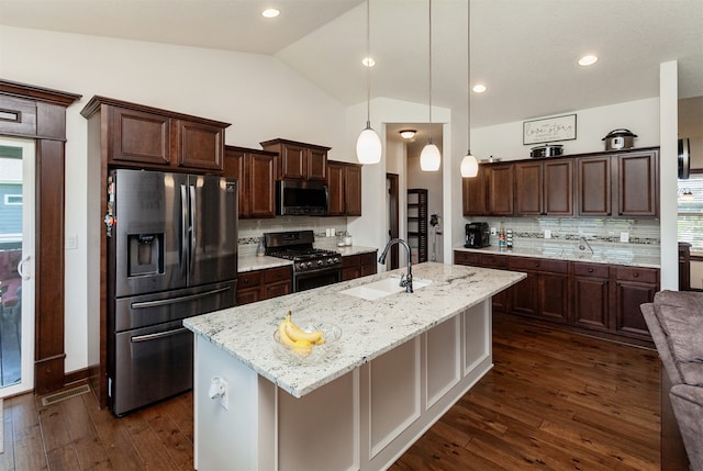 218 34th St SE, Altoona, IA 50009 - kitchen featuring stainless steel appliances, a sink, vaulted ceiling, tasteful backsplash, and dark brown cabinets