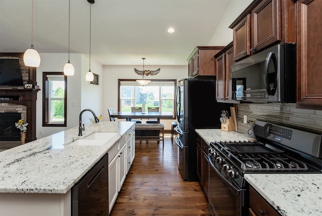218 34th St SE, Altoona, IA 50009 - kitchen featuring gas range, a sink, black dishwasher, an island with sink, and light stone counters