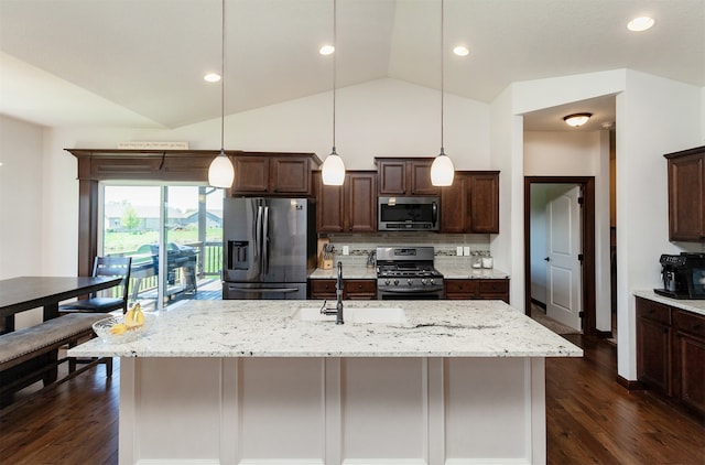 218 34th St SE, Altoona, IA 50009 - kitchen with appliances with stainless steel finishes, dark brown cabinets, lofted ceiling, dark wood-style floors, and hanging light fixtures