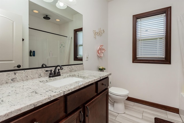 218 34th St SE, Altoona, IA 50009 - bathroom featuring plenty of natural light, toilet, vanity, and baseboards
