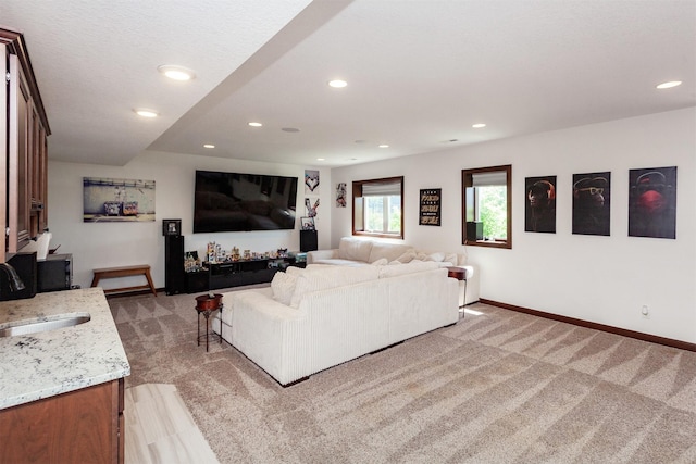 218 34th St SE, Altoona, IA 50009 - living room featuring light carpet, baseboards, and recessed lighting