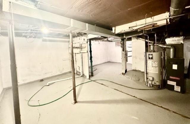 unfinished basement with water heater and heating unit