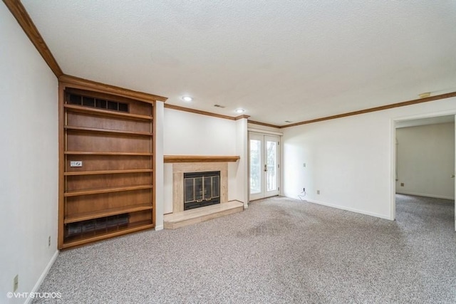 unfurnished living room featuring crown molding, baseboards, carpet, and a glass covered fireplace