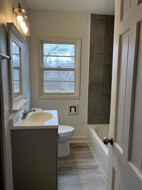 4111 Allison Ave, Des Moines, IA 50310 - full bath with vanity, baseboards, toilet, and wood finished floors