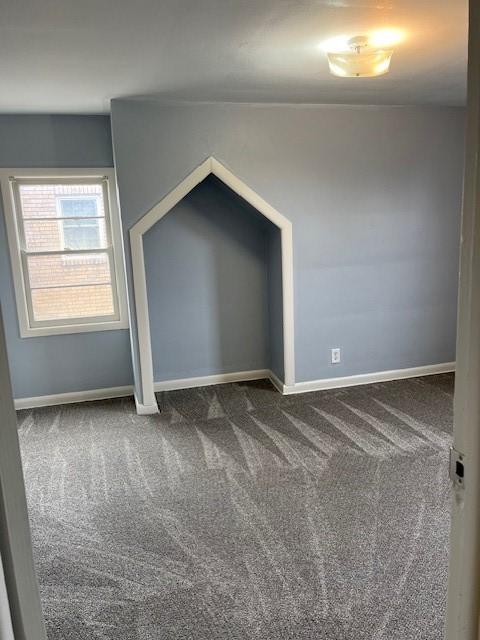 unfurnished bedroom with carpet floors and baseboards