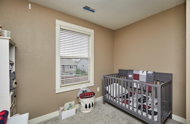 1009 NW Orchard Dr, Ankeny, IA 50023 - carpeted bedroom with baseboards, visible vents, and a crib