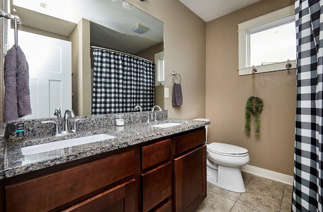 1009 NW Orchard Dr, Ankeny, IA 50023 - full bath featuring visible vents, a sink, double vanity, and toilet