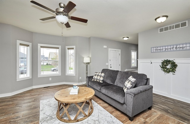 1009 NW Orchard Dr, Ankeny, IA 50023 - living room featuring baseboards, a ceiling fan, wood finished floors, and visible vents