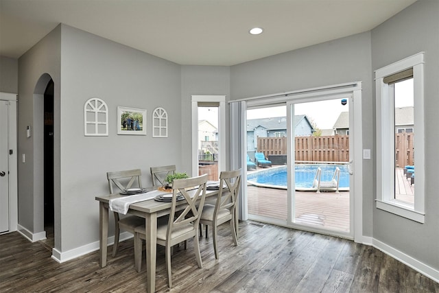 1009 NW Orchard Dr, Ankeny, IA 50023 - dining space featuring arched walkways, baseboards, recessed lighting, and wood finished floors