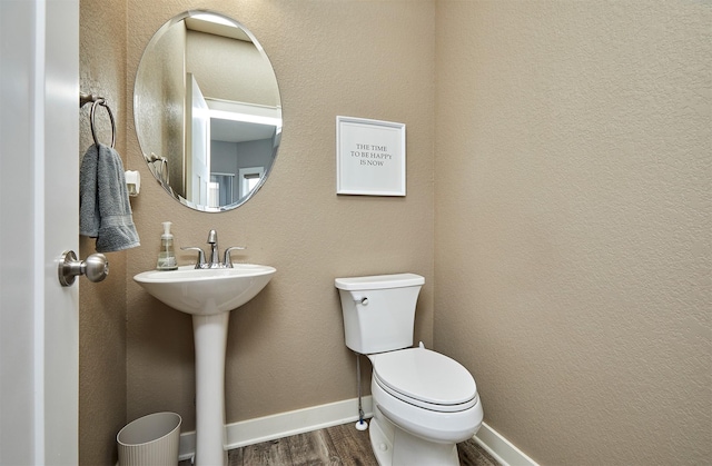 1009 NW Orchard Dr, Ankeny, IA 50023 - half bathroom with toilet, baseboards, and wood finished floors