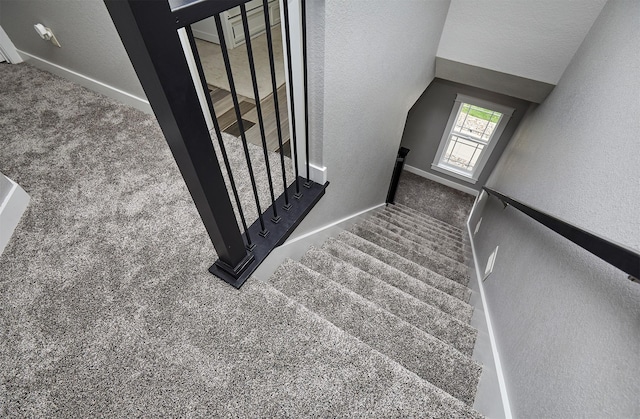 1009 NW Orchard Dr, Ankeny, IA 50023 - staircase featuring baseboards, carpet, and a textured wall