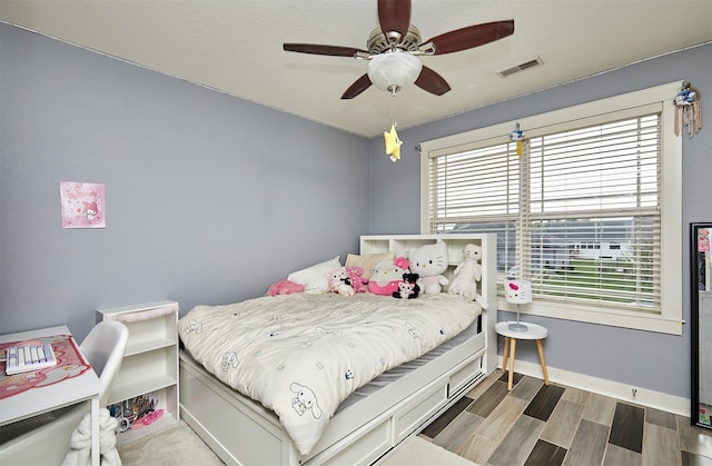 1009 NW Orchard Dr, Ankeny, IA 50023 - bedroom featuring baseboards, ceiling fan, wood finished floors, and visible vents