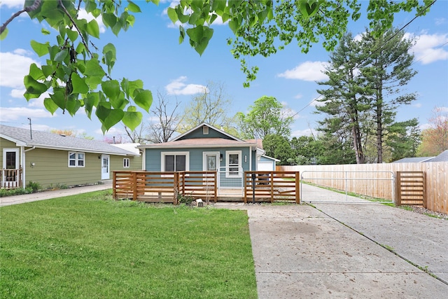 2704 50th St, Des Moines, IA 50310 - view of front of property with fence private yard, a front lawn, and an outbuilding