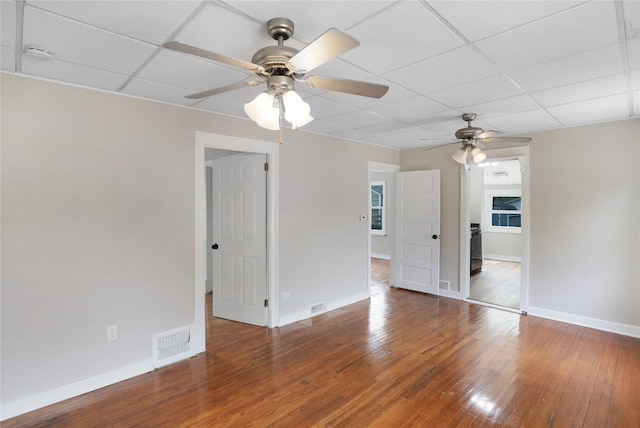 2704 50th St, Des Moines, IA 50310 - spare room featuring visible vents, wood finished floors, baseboards, ceiling fan, and a paneled ceiling