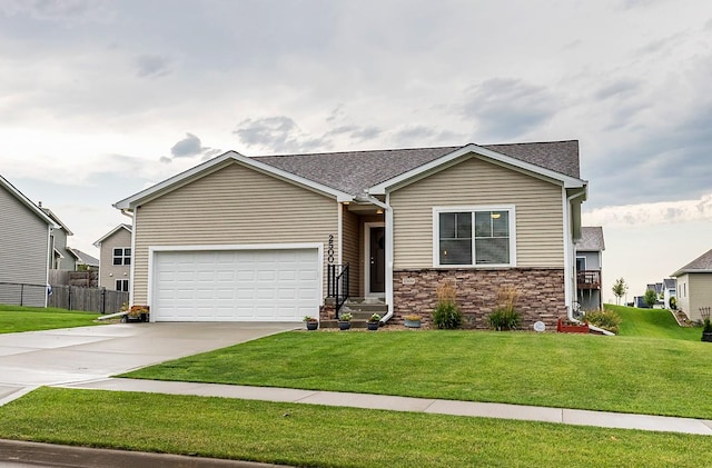 view of front of home with fence, a front lawn, stone siding, a garage, and concrete driveway