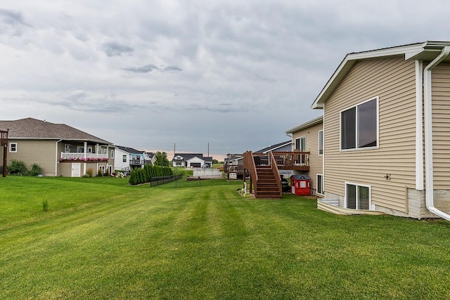 view of yard with a deck, a residential view, and stairs