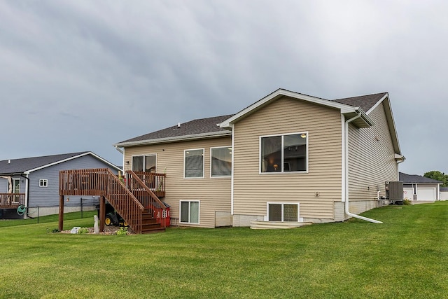 back of property with central air condition unit, stairs, a yard, and a deck