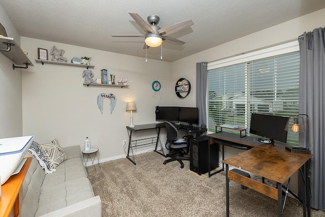 carpeted home office featuring a ceiling fan and a textured ceiling