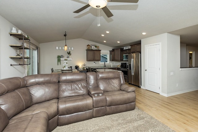 living room with light wood-style floors, a ceiling fan, baseboards, recessed lighting, and vaulted ceiling