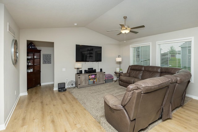 living room with ceiling fan, visible vents, vaulted ceiling, and light wood finished floors