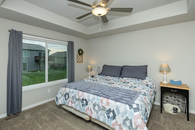 2500 N 7th Ave E, Newton, IA 50208 - bedroom featuring a tray ceiling, carpet flooring, and a ceiling fan