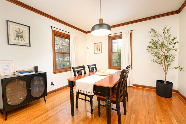 dining space with baseboards, a healthy amount of sunlight, and light wood-type flooring