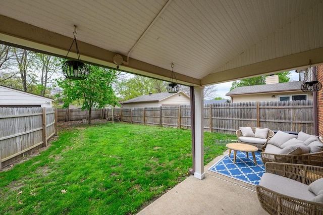 view of yard featuring a fenced backyard, a patio area, and outdoor lounge area