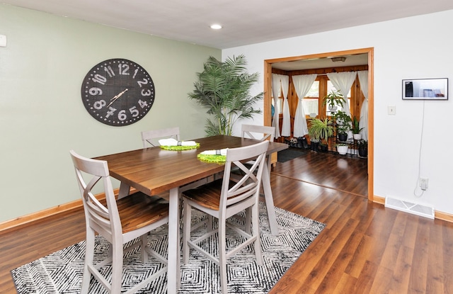 dining space with baseboards, recessed lighting, wood finished floors, and visible vents